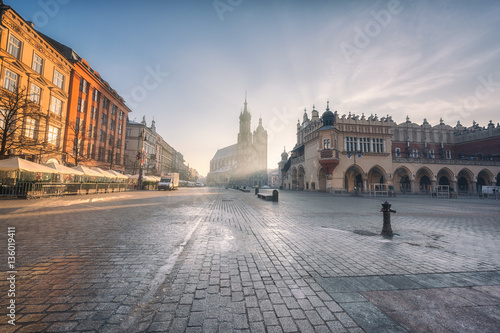 Krakow old town, Market square, St. Mary's church (Mariacki cathedral) and Cloth Hall at sunrise, wide-angle view cityscape, Poland, Europe