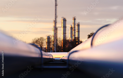 sunset at crude oil refinery with pipeline network