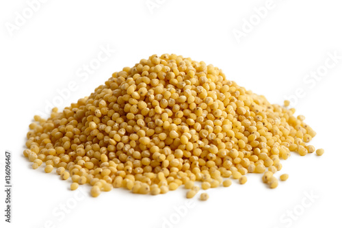 Heap of dry millet isolated on white.