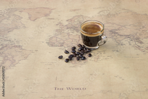 Black coffee with bean on world map background
