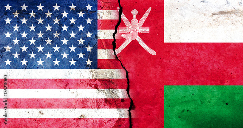 A large crack in the wall. USA flag. Flag of Oman