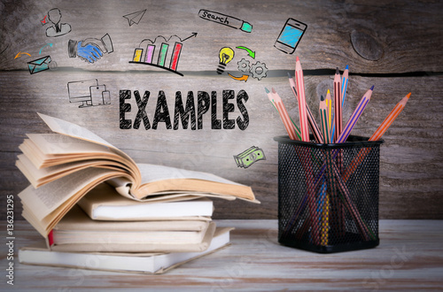 Stack of books and pencils on the wooden table.