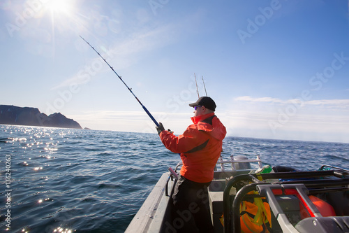 Fisherman catches athlete middle of the sea with boats