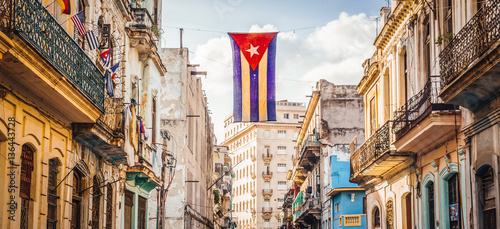 A cuban flag with holes waves over a street in Central Havana. La Habana, as the locals call it, is the capital city of Cuba