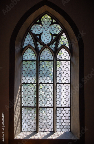 Light through a Gothic stone church window in Schaffhausen, Switzerland