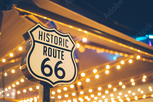 Historic Route 66 sign in California with decoration lights on the background