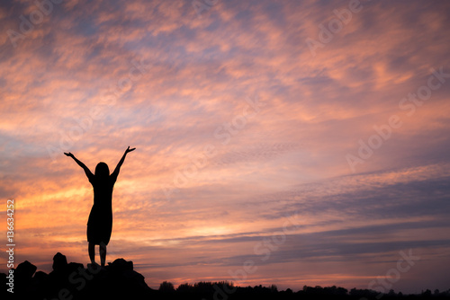 woman enjoying beautiful sunset.