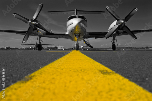 Color key picture of a Piper Cheyenne IV parked on the apron waiting for passengers.