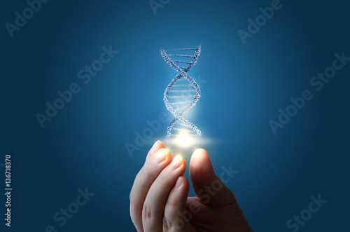 DNA in hand on blue background.