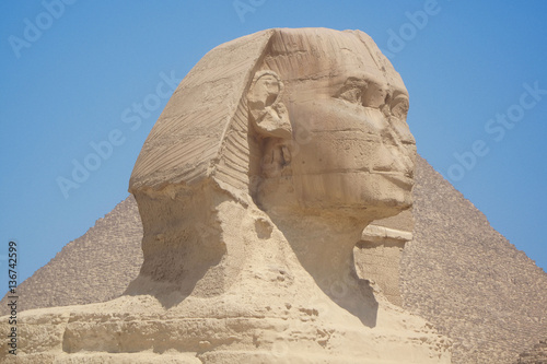 Closeup view of the Sphinx head with pyramid in Giza near Cairo, Egypt