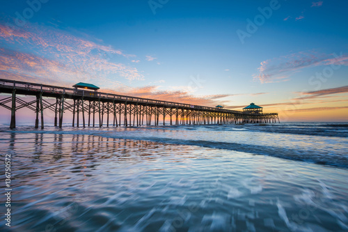 Waves in the Atlantic Ocean and the pier at sunrise, in Folly Be