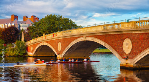 Harvard University scull team rowing practice. Motion blur going under bridge.