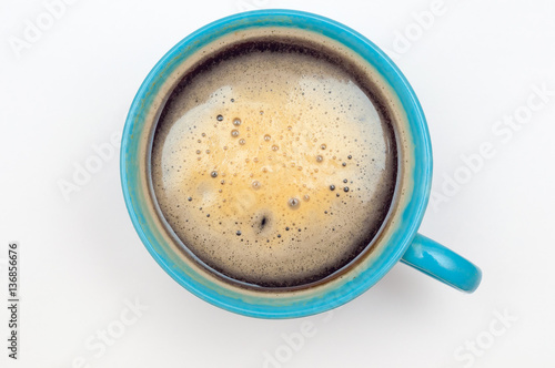 Blue cup of coffee. Espresso isolated on white, top view.
