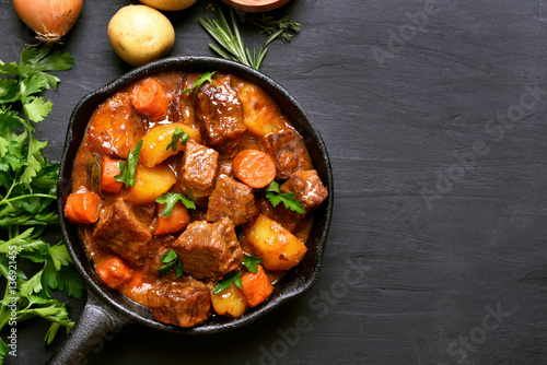 Beef stew with potatoes, carrots and herbs