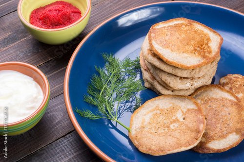 Russian buckwheat pancakes blini with cream and caviar