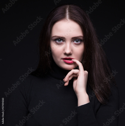 Portrait of woman with pinky finger