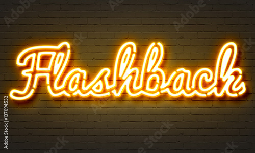 Flashback neon sign on brick wall background.