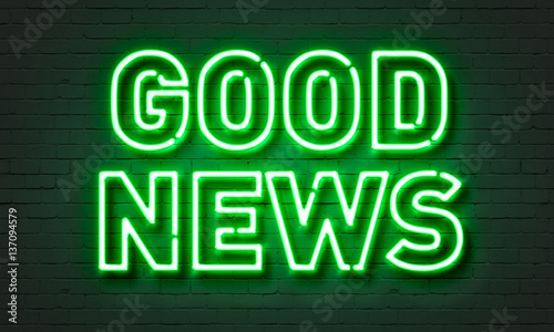 Good news neon sign on brick wall background.