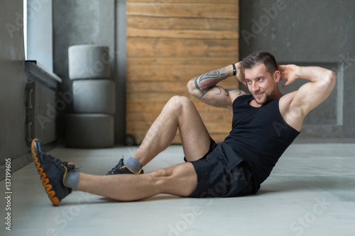 Young man fitness workout, cross crunches for abs