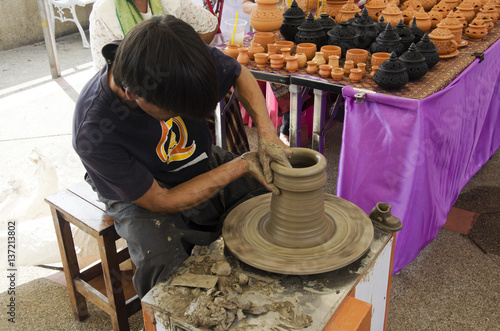 Professional thai old man using mechanic pottery made earthenware in traditional culture thai festival at Koh Kret Island