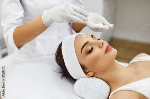 Girl At Spa Salon. Beautician Applying White Cosmetic Powder