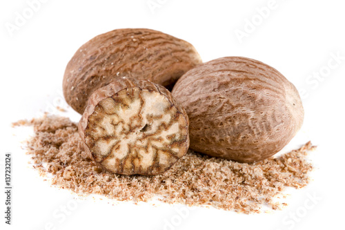 Three nutmeg and powder isolated on white background