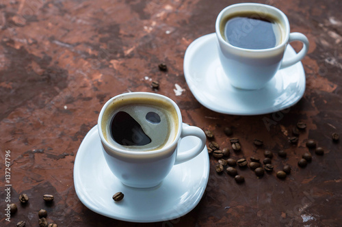 A Cup of espresso on brown background