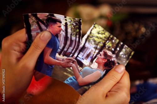 Broken heart woman. Couple break up. Woman and man quarrel. Close up of female hands tearing family pictures.