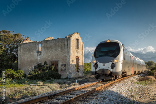 Train passing derelict station at Lumio in Corsica