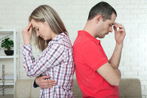 Man and woman standing back to back after quarrel