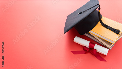 academic hat with diploma and books