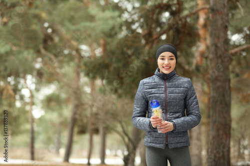 Young woman jogging in winter park