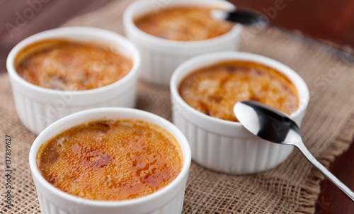 Creme brulee in a white bowl with sugar crust. Studio photography. country style.