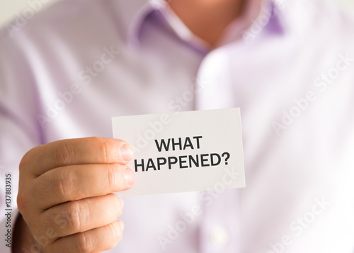 Businessman holding a card with text WHAT HAPPENED ?