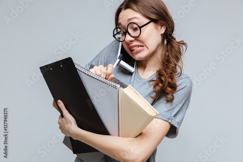 Shocked Clumsy female nerd talking on phone