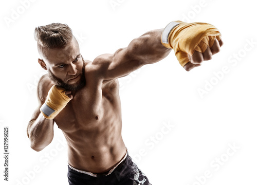 Man throwing a fierce and powerful punch. Photo of muscular man isolated on white background. Strength and motivation.