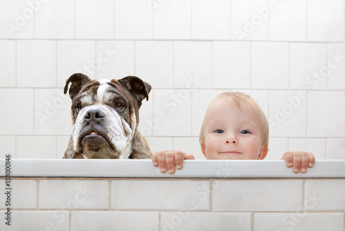 child and dog in the bathtub