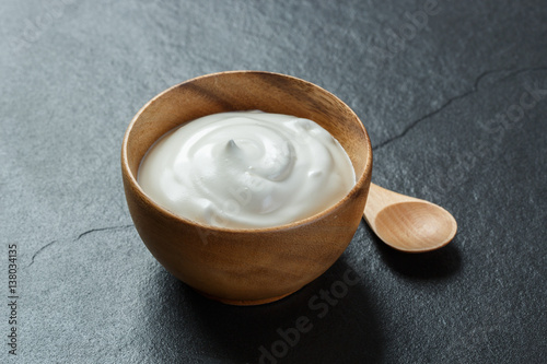 Greek yogurt on black stone background