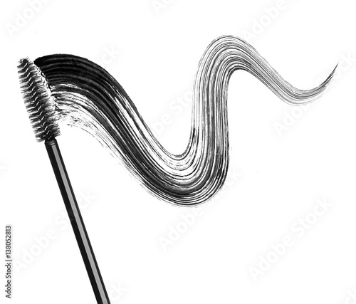 Stroke of black mascara with applicator brush close-up, isolated on white background