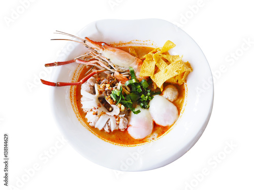 white bowl of Tom Yum Kung with noodles and seafood isolated