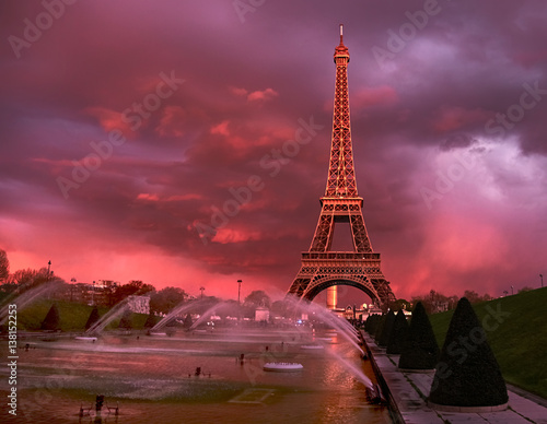 Eiffel tower on a sunset half-lit with last rays of the setting sun