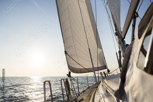 Luxury Sail Boat Sailing In Open Sea During Sunrise