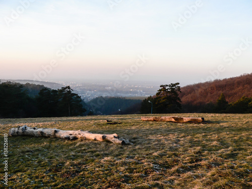 View from Ahoj mountain on Piestany city with forest, meadow and misty clouds