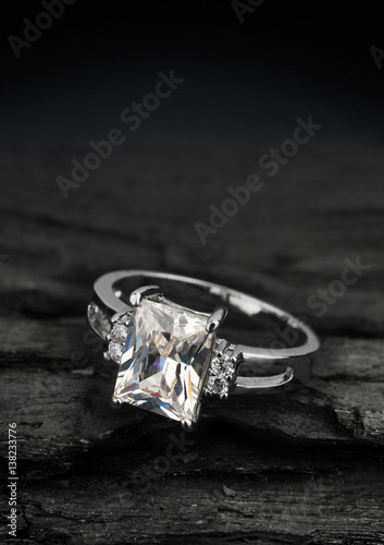 jewelry ring witht big diamond on dark coal background