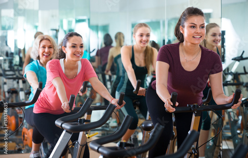 Females riding stationary bicycles