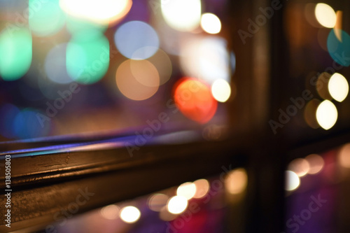 Colorful City Lights Flickering Through a Window