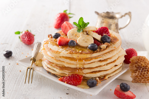 delicious pancakes on wooden table with fruits