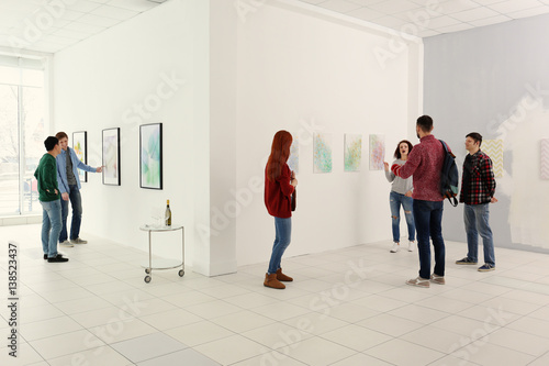 Young people in modern art gallery hall