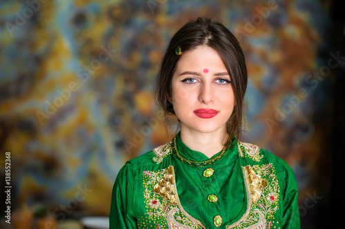 Portrait of beautiful eastern woman in green sari