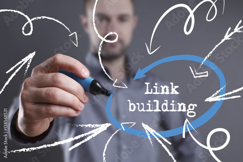 Technology, internet, business and marketing. Young business man writing word: Link building